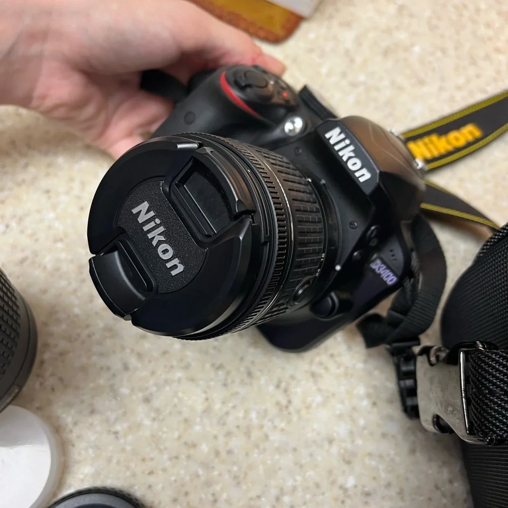 Nikon D3400 DSLR Camera with two lenses, 2 batteries, battery charger, and bag